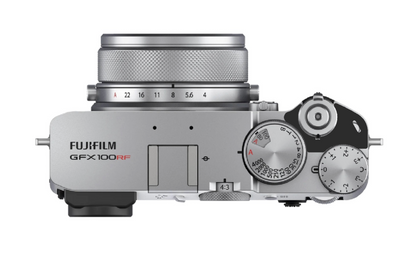 Fujifilm GFX100RF mirrorless camera body in silver with a matching silver lens, shown from a top-down view on a white background with a power switch lock installed.