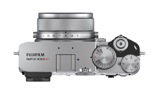 Fujifilm GFX100RF mirrorless camera body in silver with a matching silver lens, shown from a top-down view on a white background with a power switch lock installed.